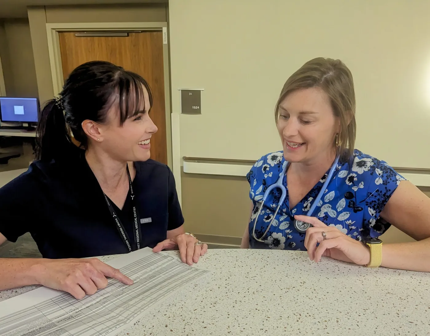 Two SRMC nurses reviewing a patient's care plan together
